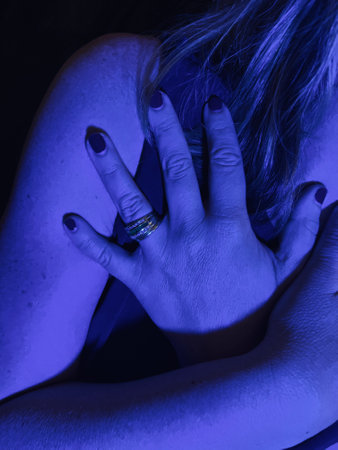 Hand of married woman with wedding and engagement rings and manicured nails with painted varnish...