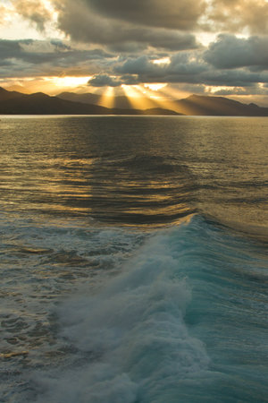 Sunset over the sea and mountains in the background. High quality photoの写真素材