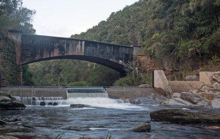 Old bridge over a river in the mountains. The bridge is over the river.の写真素材