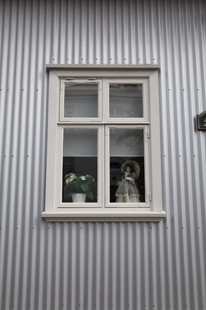 doll looking out from the windowの写真素材
