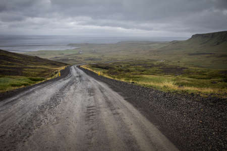 go down unpaved road in icelandの写真素材
