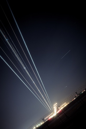 light trail of aircraft while landingの写真素材