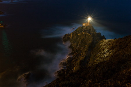 lighthouse light  switched on during nightの写真素材