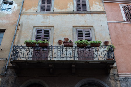 traditional balcony in historical center in Italyの写真素材