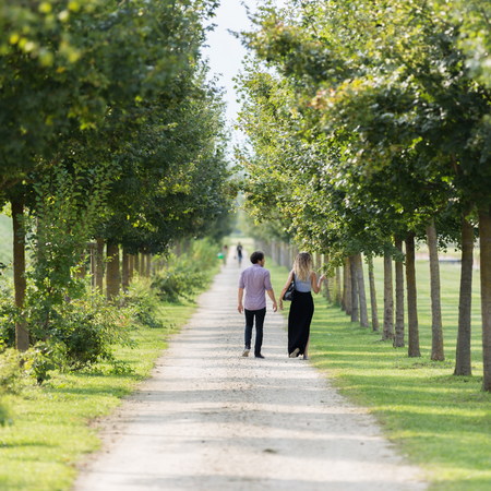 young couple admiring landscape while walkingの写真素材