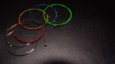 multicolor guitar strings on dark backgroundの写真素材