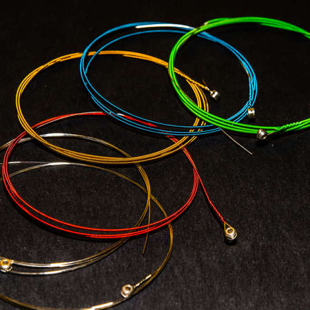 multicolor guitar strings on dark backgroundの写真素材