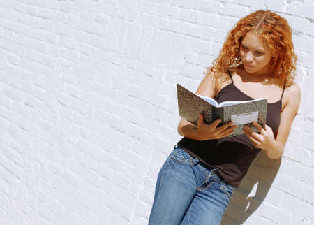 Attractive urban girl against white brick wall.の写真素材