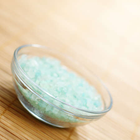 Colored bath salt displayed on top of a bamboo mat.の写真素材