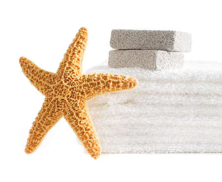 Starfish, towels, and pumice stones against a white background.の写真素材