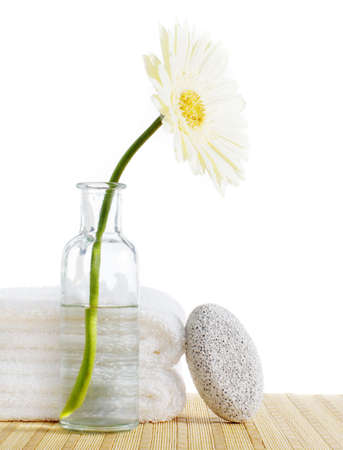 Flower, towels, and pumice stone against a white background.の写真素材