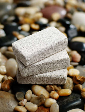 Pumice stones on display on top of river rocks.の写真素材