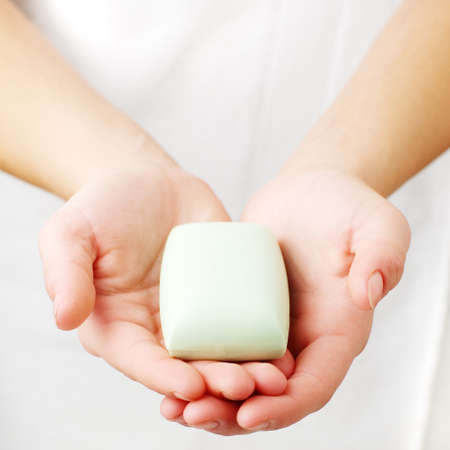 Closeup of womans hands holding spa treatment.