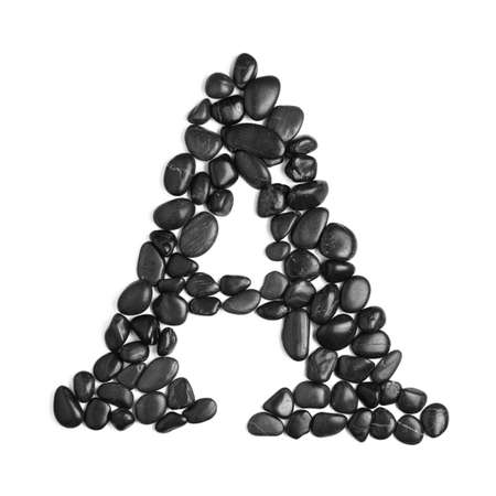 Black rock letter photographed against a white background.の写真素材