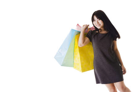 Beautiful Chinese woman with shopping bags in front of a white background.の写真素材