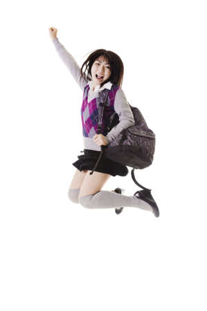 Female Chinese student with a backpack on a white background jumping in the air.の写真素材