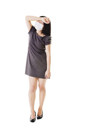 Sick Chinese woman wearing a face mask about to faint.の写真素材