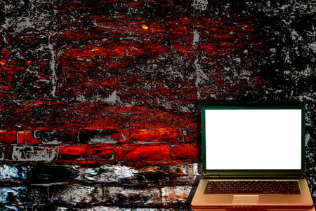 Modern laptop computer with grunge antique wall backgroundの写真素材