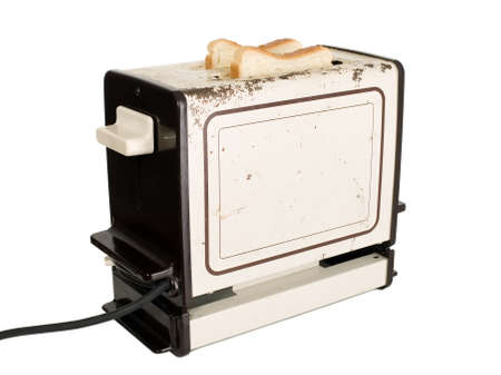Old fashioned toaster with slice of breadの写真素材