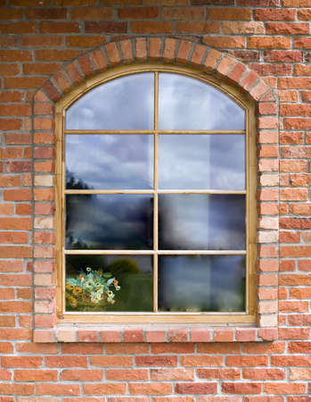 Brown window in old red brick wall