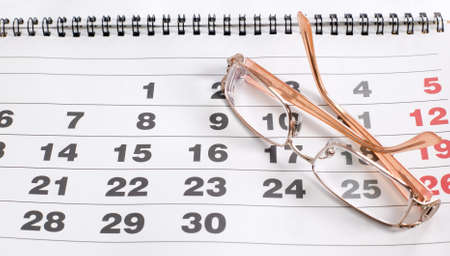 There is eyeglass on calendar to schedule plansの写真素材