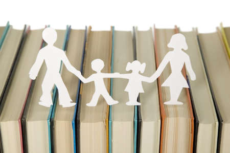 Family figures made from paper with books background, school themeの写真素材
