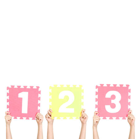 Children are holding numbers one two three in their hands