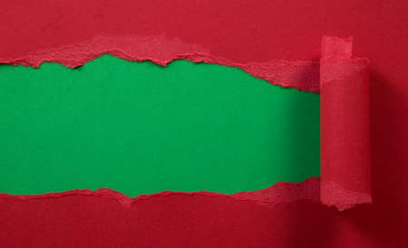 Ripped red paper with green background, frame compositionの写真素材