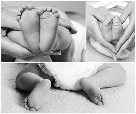 Mother is holding legs of baby boy in her handsの写真素材