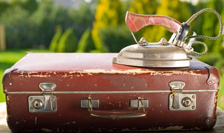 Vintage old brown suitcase on green nature backgroundの写真素材