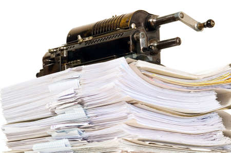 Vintage calculator placed on the top of document bunch