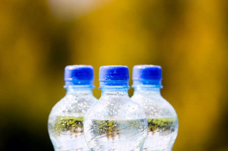 Mineral water bottles with blue plastic corkの写真素材