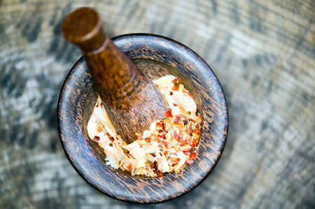 Wooden pestle filled with fruits and gritsの写真素材