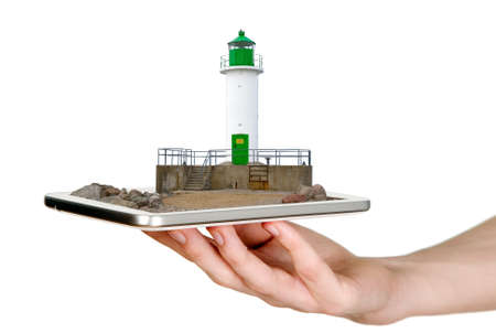 Man is showing white lighthouse with green detailsの写真素材