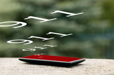 Mobile phone placed on wooden floor with nature backgroundの写真素材