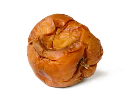 Old rotten apple on white isolated background, unhealthy to eatの写真素材