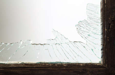 Broken window glass with wooden vintage frame aroundの写真素材