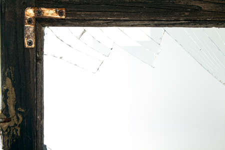 Broken window glass with wooden vintage frame aroundの写真素材