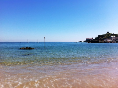Tenbys North Beach as the tide advances on a sunny day in Wales.の素材