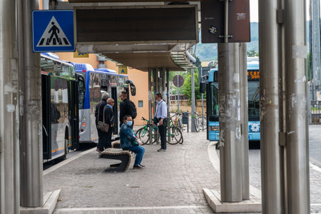 terni,italy may 29 2020:bus at the station and drivers waiting to leave with masks for covid emergencyのeditorial素材