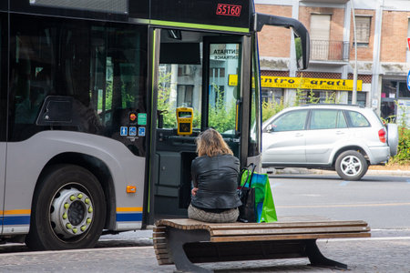 terni,italy may 29 2020:woman at station on bench with mask for covid emergency waiting to leave with busのeditorial素材