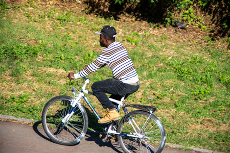 terni,italy may 31 2020 :man riding a bike in the park in the morningのeditorial素材