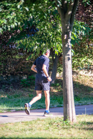 terni,italy may 31 2020 : woman doing physical activity at park in the morningのeditorial素材