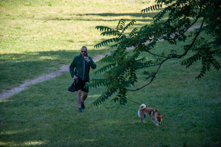 terni,italy may 31 2020 :man carrying dog to park in solitude in the morningのeditorial素材