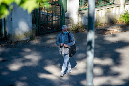 terni,italy june 01 2020 :man walking with mask at park in the morningのeditorial素材