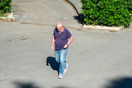 terni,italy june 01 2020 :man walking with mask at park in the morningのeditorial素材