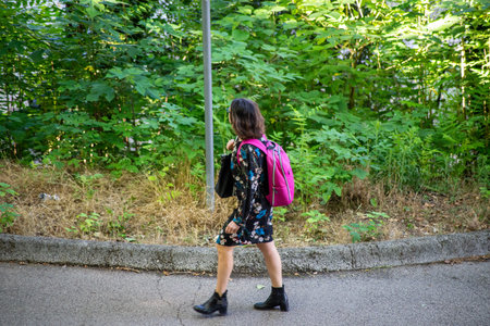 terni,italy june 01 2020 :girl with backpack at park in the morningのeditorial素材