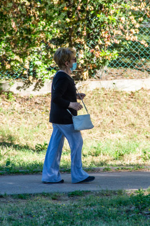 terni,italy june 01 2020 :woman strolling wearing mask at parkのeditorial素材