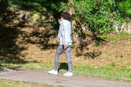 terni,italy june 01 2020 :woman strolling wearing mask at parkのeditorial素材