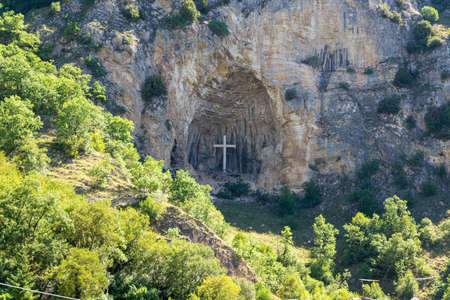 cross placed in a niche on a mountainの写真素材